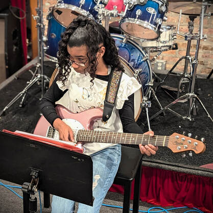 Picture of one of our guitar gas while she is rocking during the recital