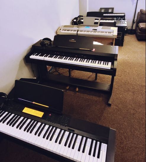 Picture of our piano lab. In this picture there are 5 professional level keyboards that are ready to be played and learned on! 